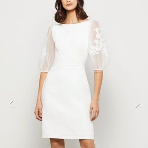 Brand new, with tags, never worn, BCBGMAXIA white dress with lace puff sleeves